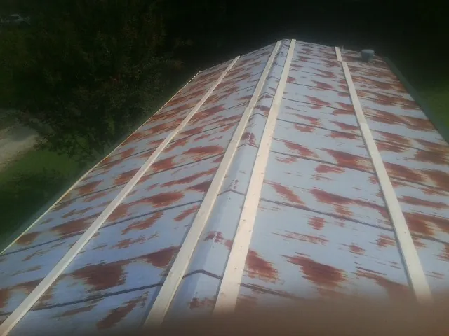 Rusted metal roof panels with new wood purlins before replacement — Storm Damage Roof Repair in Claymont by Roofing Brothers