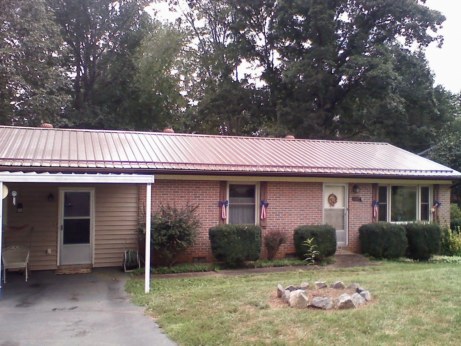 Bronze metal roof and carport on a brick ranch home — Roof Repair work by our crew in Claymont